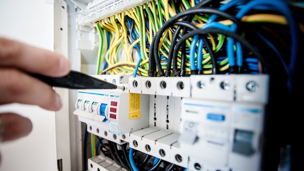 Electrical safety and energy control - electrician working on panel