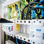 Electrical safety and energy control - electrician working on panel